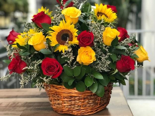 yellow lilies and red carnations basket