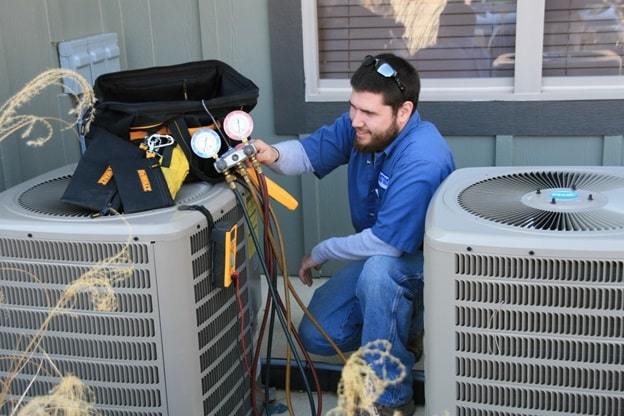 man repairing air conditioner
