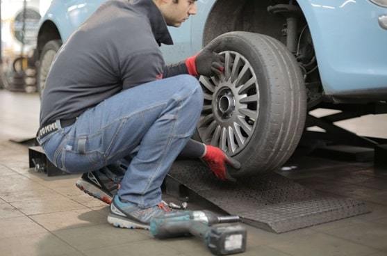 car mechanic changing tire