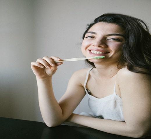girl smiling with toothbrush