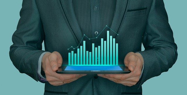 person holding a tablet with a graph of business growth
