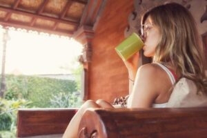 woman drinking tea watching sunset