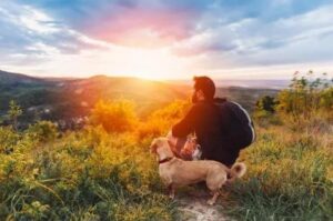 Best Tips to Treat Depression Naturally man dog enjoying hilltop views
