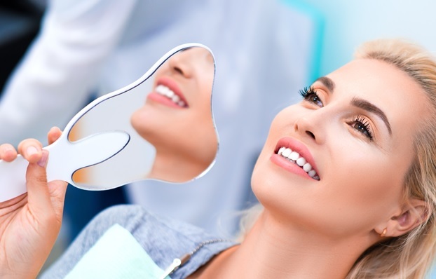 close up photo of a smiling woman in dental clinic