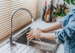 close up shot of woman washing hands in sink