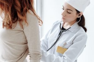 doctor woman checkup female patient's back in a hospital