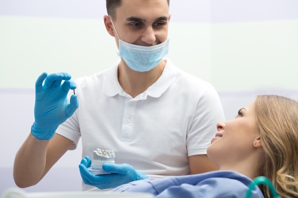 dentist and patient during dental implant