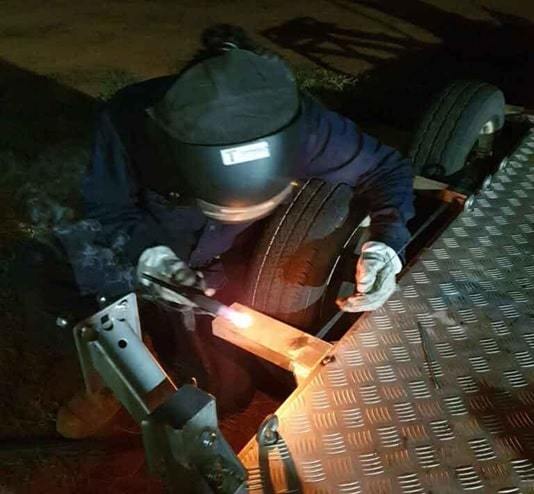 person doing welding with helmet