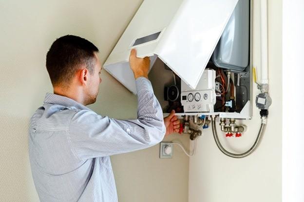 electrician inspecting heater system