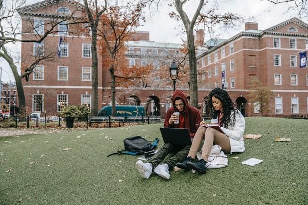 students learning outside classrooms on campus ground