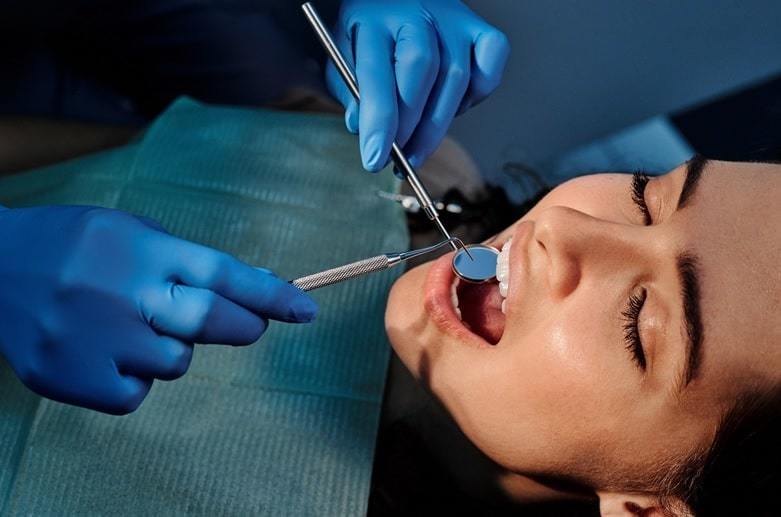 dentist operating female patient