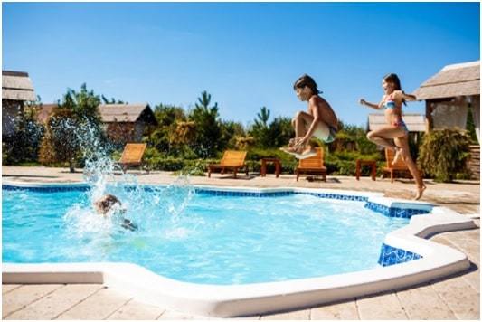 kids jumping in swimming pool