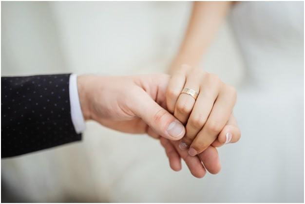 newly wed couple hands with wedding rings
