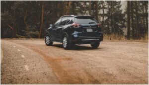 black rogue suv on muddy road