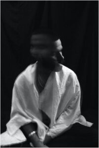 depressed young man with blurred head in dark room