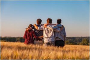 friends standing together in a field background