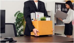 businessman packaging and holding brown cardboard box with documents