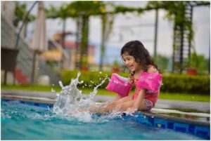 5 Things You Didn’t Know About Building a Backyard Pool girl in pink shirt on swimming pool during daytime