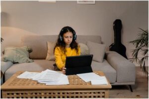 girl with headphones is using laptop listening music
