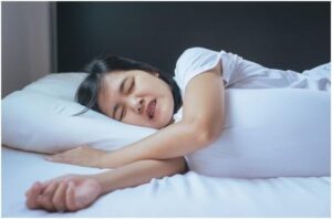 woman sleeping on the bed and grinding teethtiredness, stress