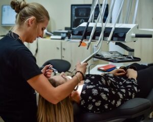 A Regular Dental Check-Ups: Why are They so Important? woman in black and white floral top lying on chair