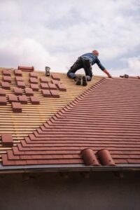 roofer working on new house roof installation