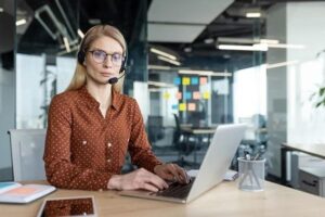 woman with headset works at her desk