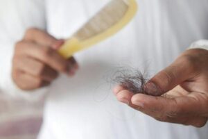 man hold his list hair close up