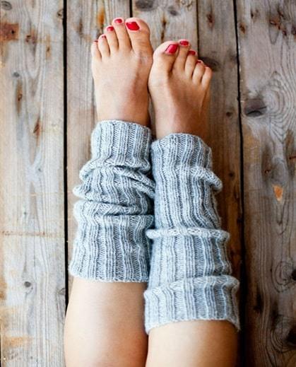 a woman's feet with red nail polish and a pair of socks