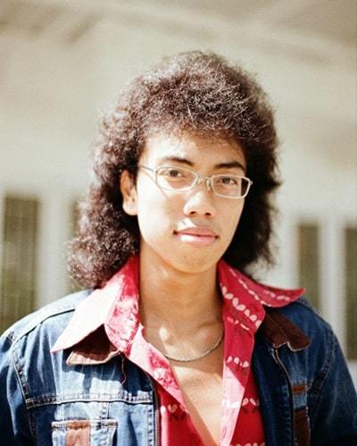 woman in blue jacket wearing eyeglasses