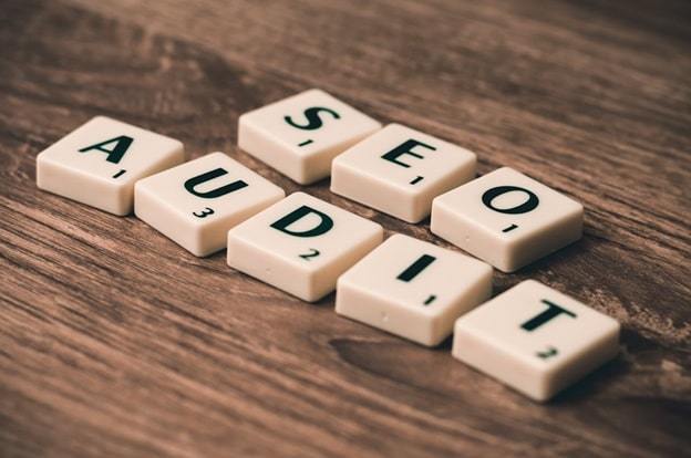 seo audit concept spelled with scrabble tiles on wooden table
