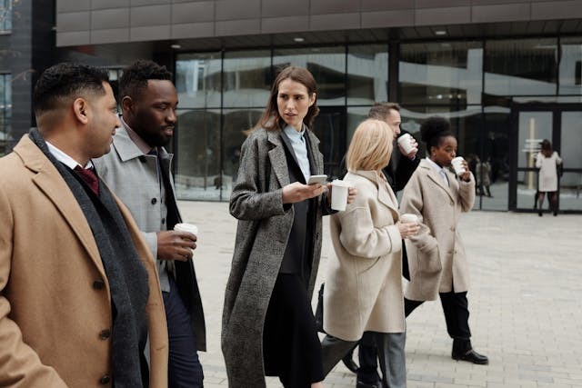 business people walking with coffee cups