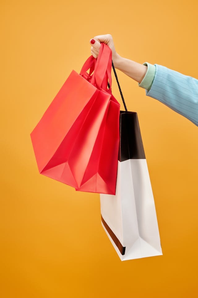 close-up of a woman holding colorful shopping bags