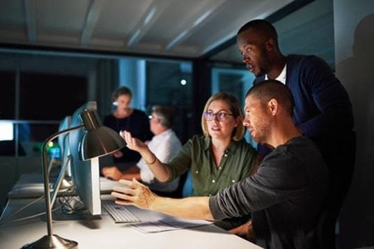 shot of businesspeople working late in an office