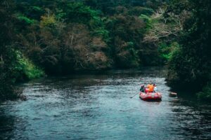 How to Get Involved in Water Sports for Fun three persons riding red inflatable raft