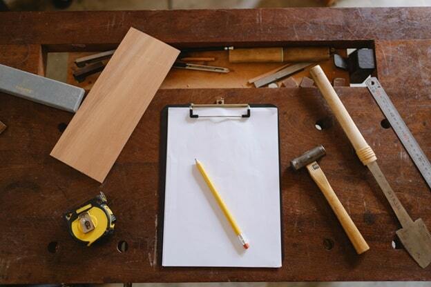 yellow pencil on white paper and carpentry tools