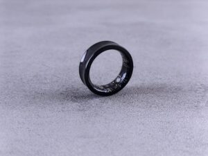 sleek black smart Ring on concrete surface