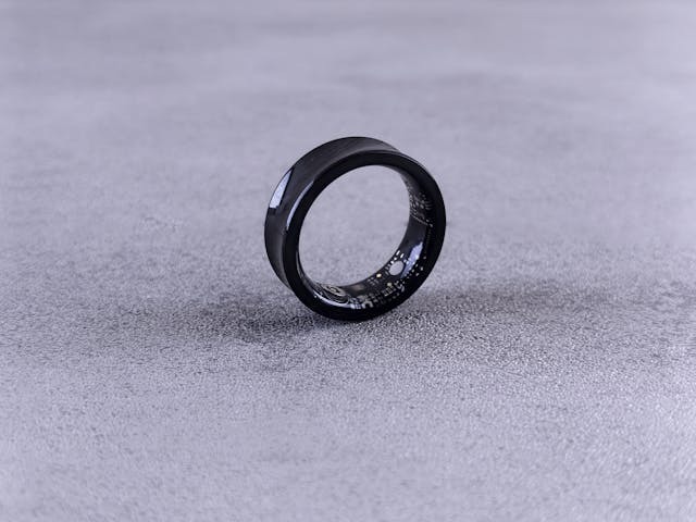 sleek black smart Ring on concrete surface