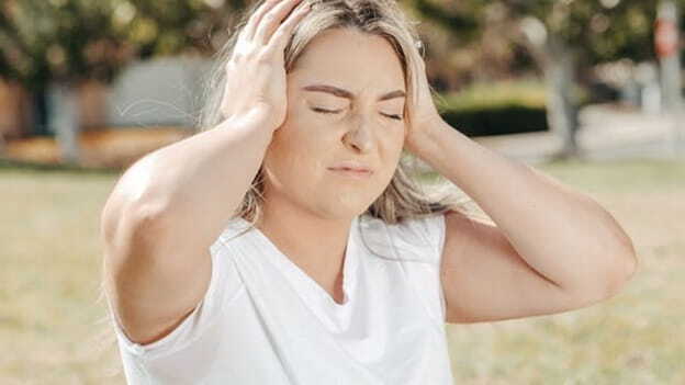 a woman holding her head