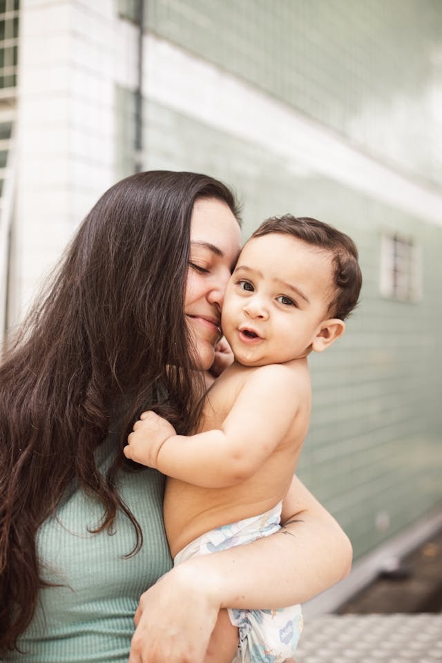a woman holding a baby in her arms
