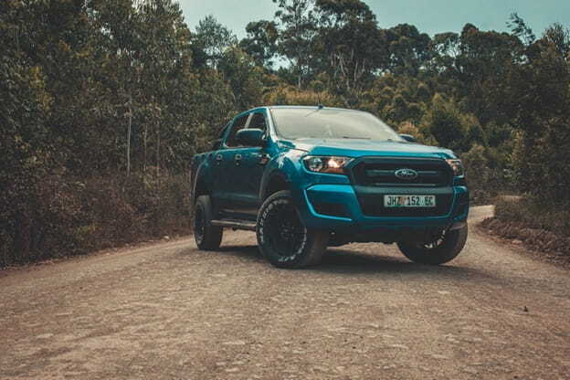 blue ford ranger on dirt road