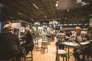 5 Design Tips for Creating a Memorable Exhibit Space people inside a cafe with tables and chairs