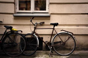 6 Ways to Transport Bikes Safely on the Road vintage bicycles leaning against rustic wall