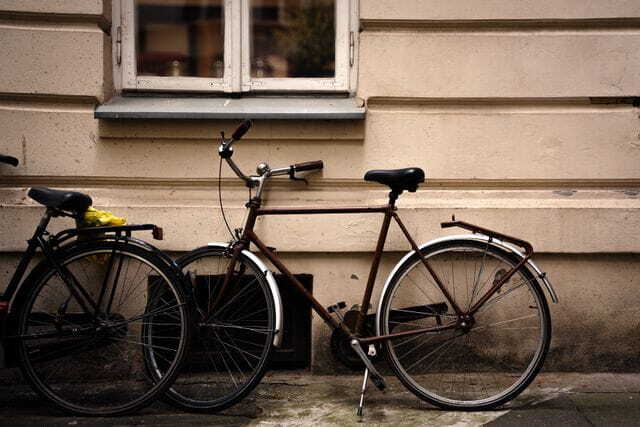 vintage bicycles leaning against rustic wall