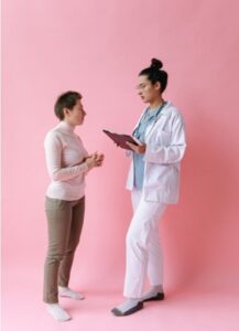6 Ways Pelvic Floor Strength Impacts Everyday Quality of Life a woman with short hair consulting a doctor