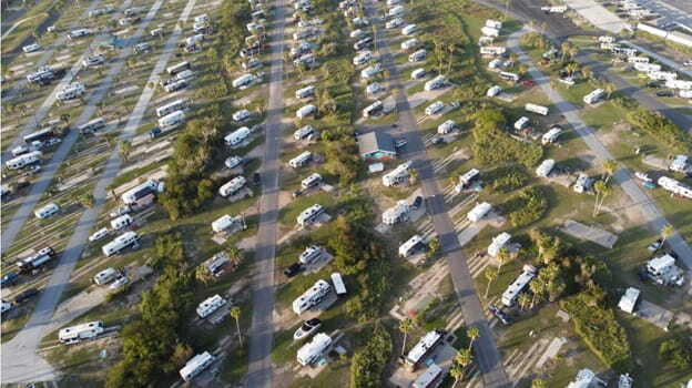 aerial footage with campers on a car park