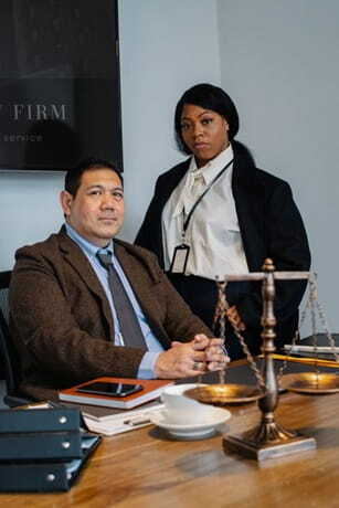 diverse lawyers near wooden table