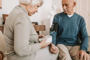 The Rise of Wellness-Focused Communities for Older Adults man in blue sweater sitting beside man in gray sweater