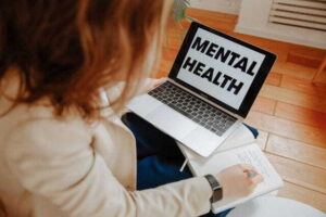 a woman participating in an online therapy session