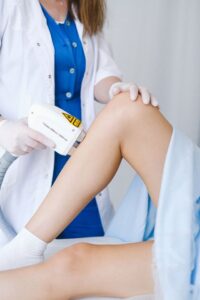 5 Benefits of Working with an Experienced Aesthetic Provider healthcare professional performing laser treatment in a medical clinic.